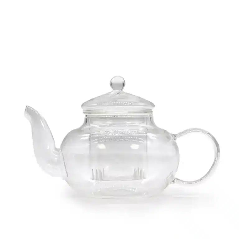 A clear glass teapot with a rounded body, a spout on the left, a curved handle on the right, and a lid with a round knob on top.