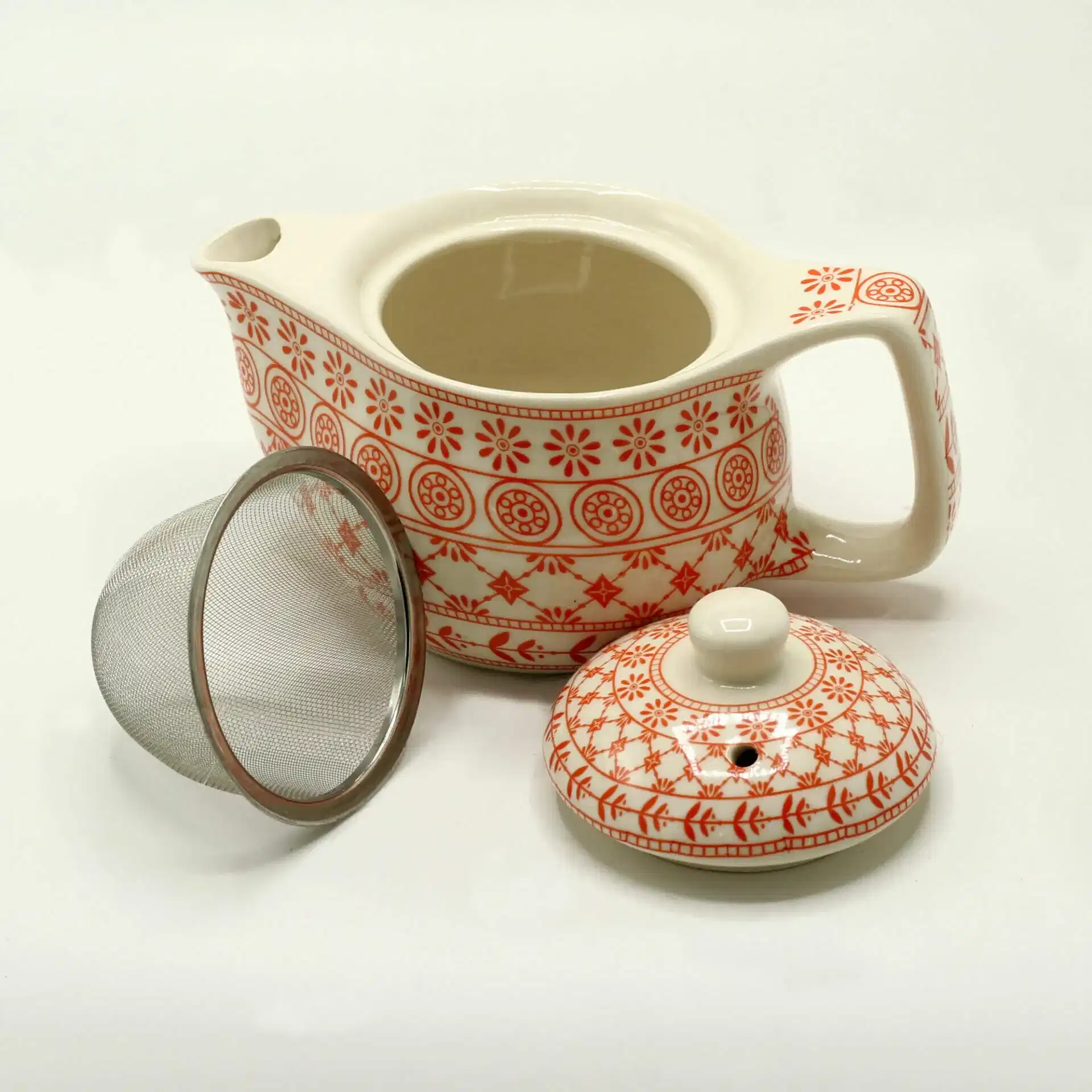 A patterned ceramic teapot with a matching lid and a metal mesh tea infuser, displayed on a plain white background.