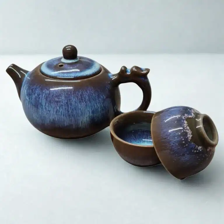 The Ocean Blue Teapot for One | Aqua Teal Tea Set with 2 Cups features a brown and blue glaze, complete with matching cups and lid—an elegant addition to any tea cups collection.
