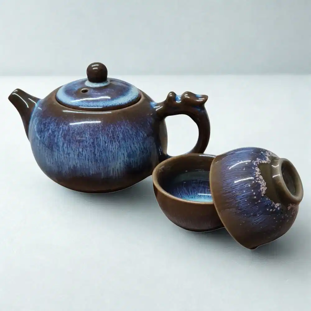 The Ocean Blue Teapot for One | Aqua Teal Tea Set with 2 Cups features a brown and blue glaze, complete with matching cups and lid—an elegant addition to any tea cups collection.
