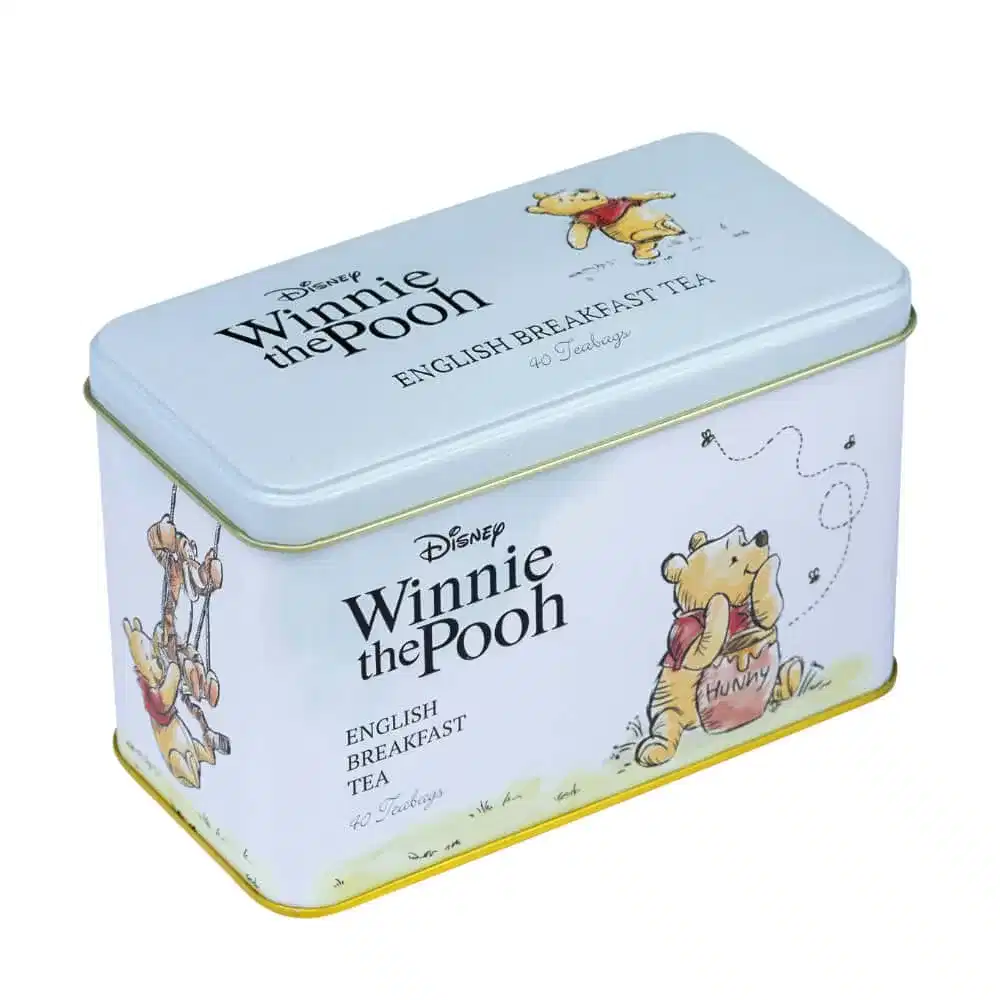 A charming tin featuring Winnie the Pooh illustrations, showcasing him savoring honey and swinging, adorned with 