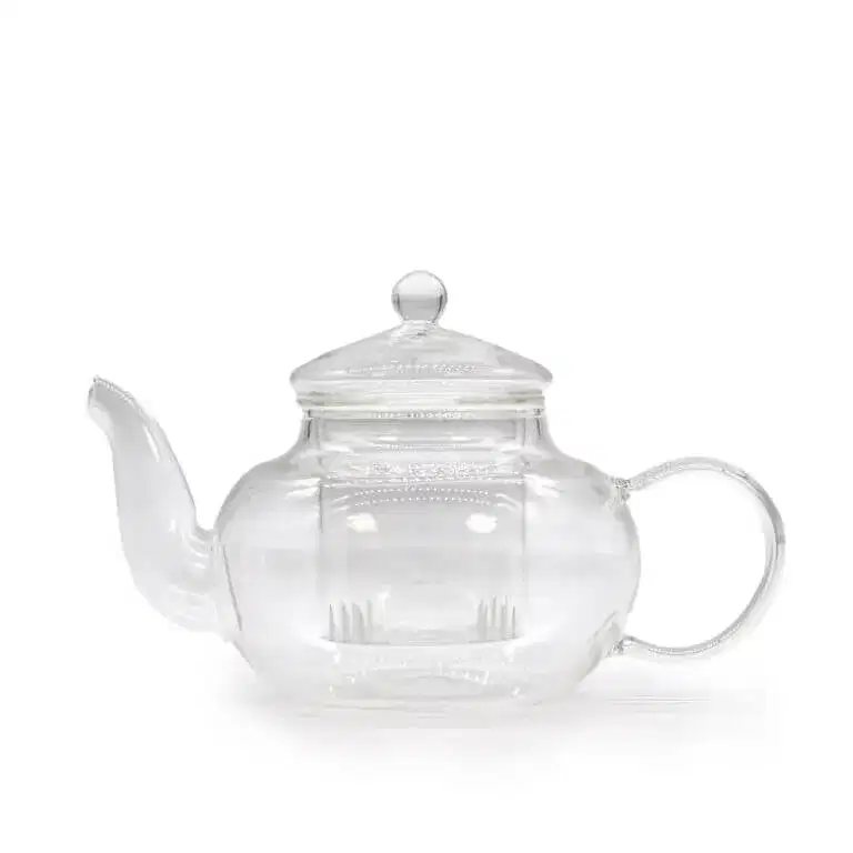 A clear glass teapot with a rounded body, a spout on the left, a curved handle on the right, and a lid with a round knob on top.