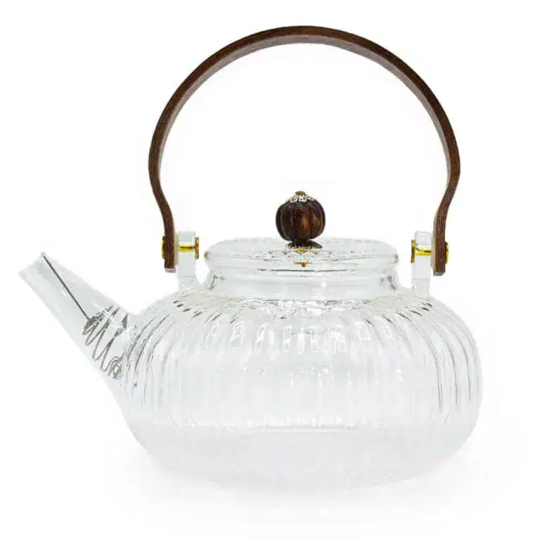 Clear glass teapot with a ribbed design, short spout, round wooden handle, and matching wooden knob on the lid.