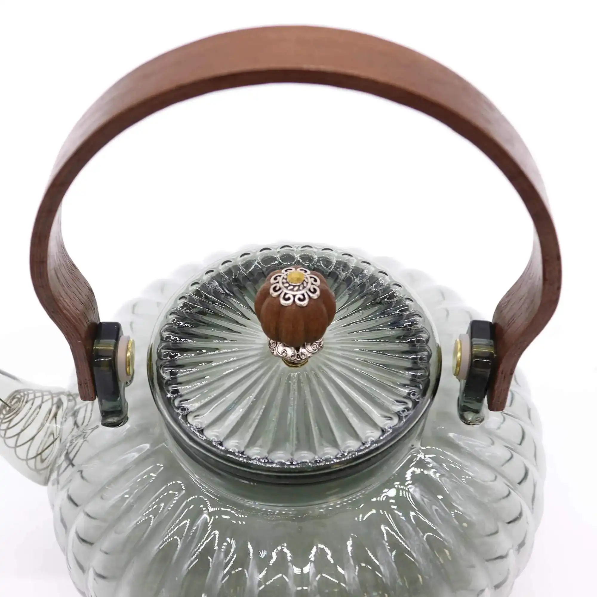 Clear glass teapot with a ribbed design, wooden handle, and a matching ribbed glass lid featuring a decorative wooden knob with a small floral detail.