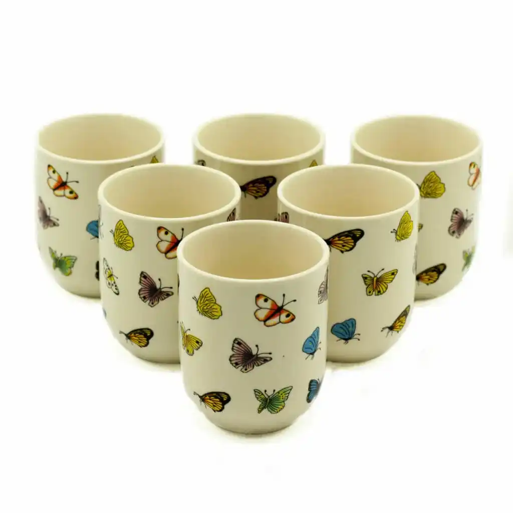 Six white ceramic cups are arranged in two rows, each decorated with colorful butterfly illustrations.