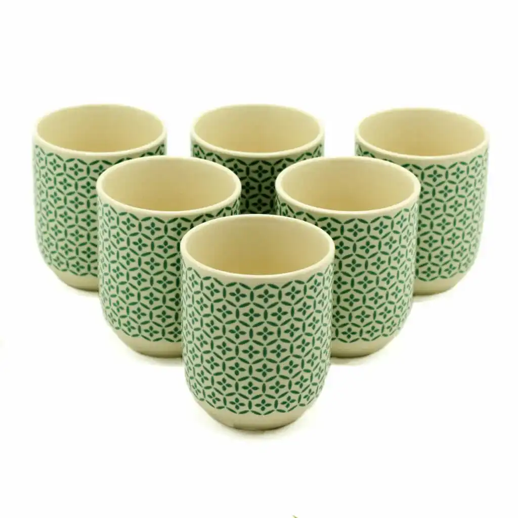 Six ceramic cups with a green geometric pattern are arranged in two rows on a white background.