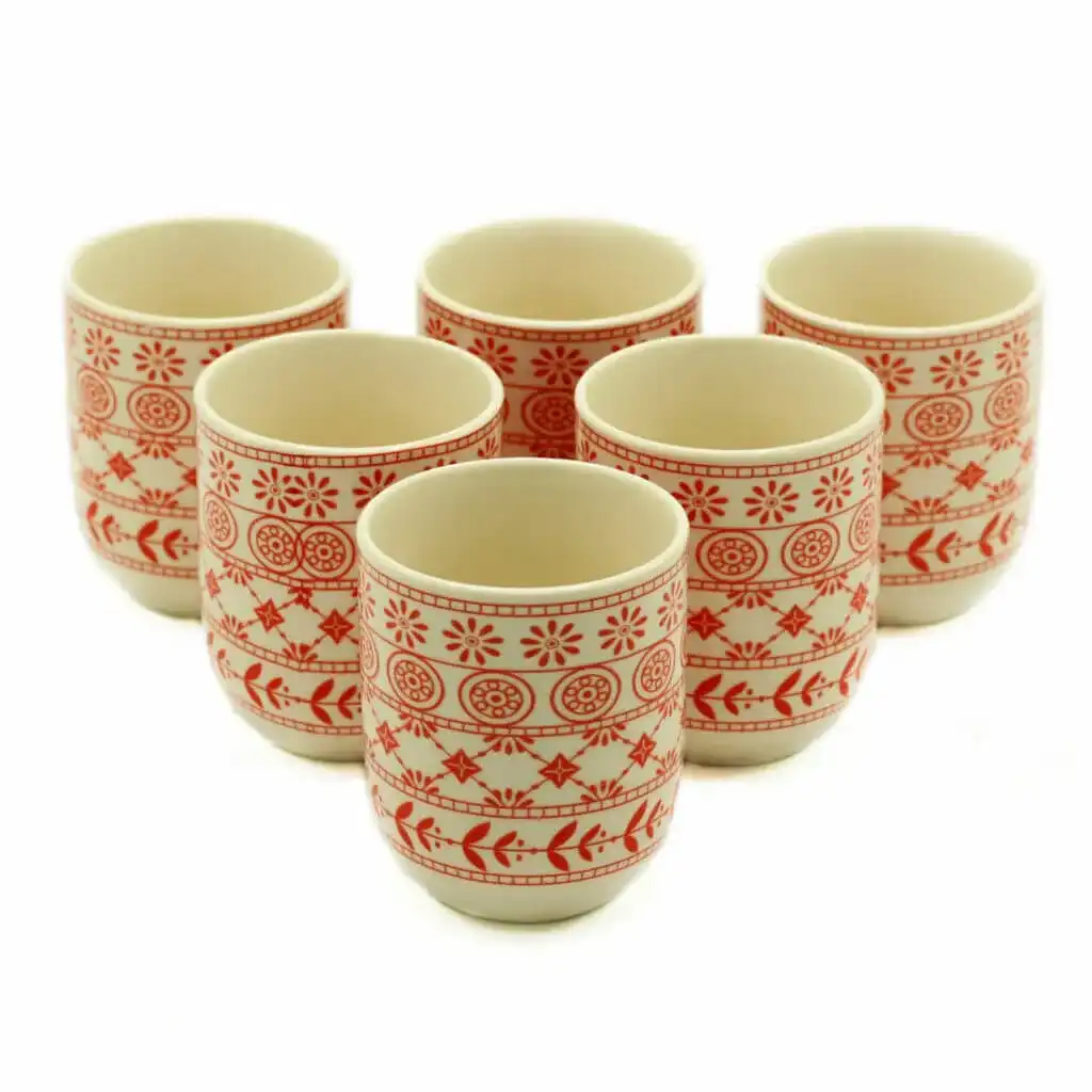 Six ceramic cups with red geometric and floral patterns arranged in two rows on a white background.