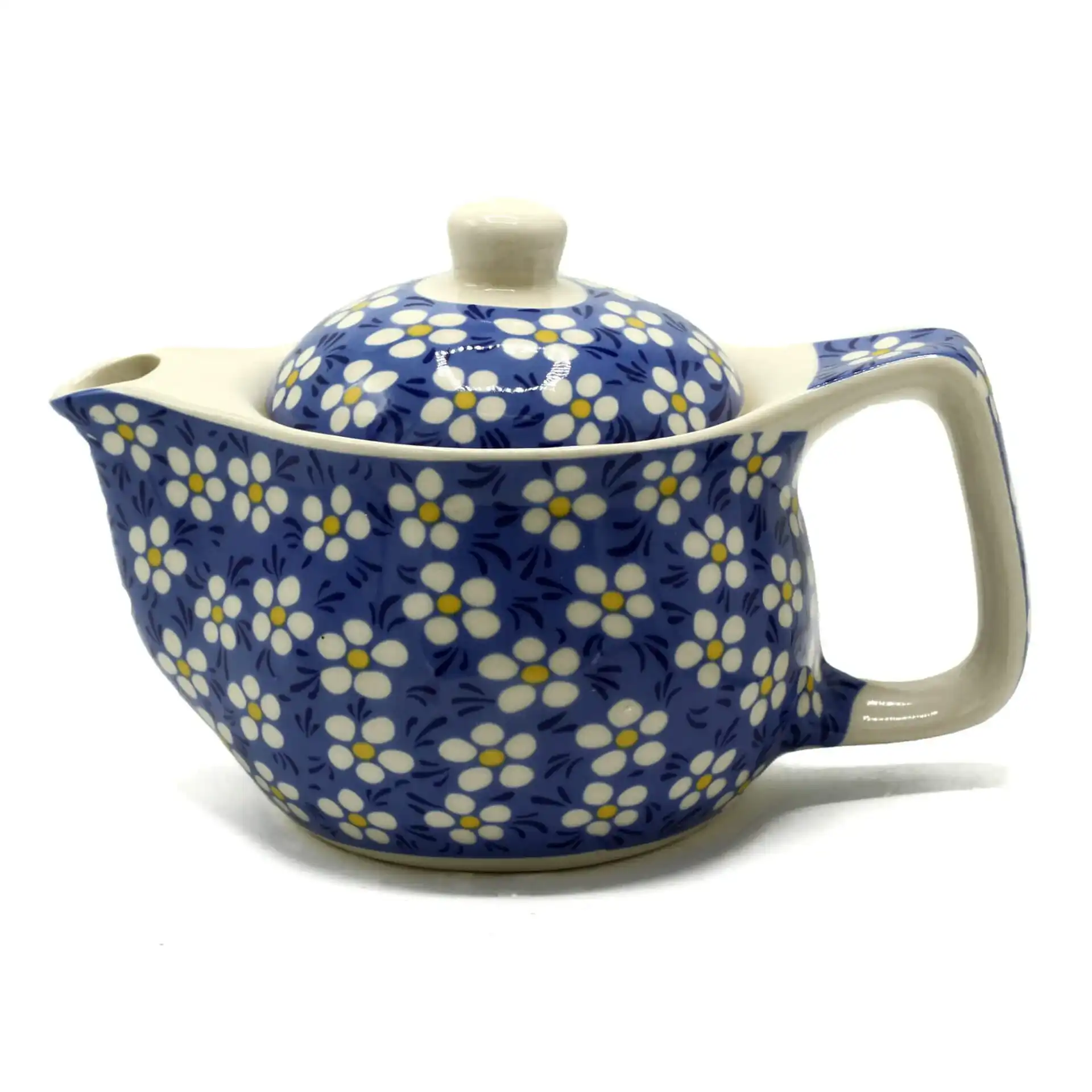 A ceramic teapot with a blue background and white and yellow floral pattern, featuring a large handle and matching lid.