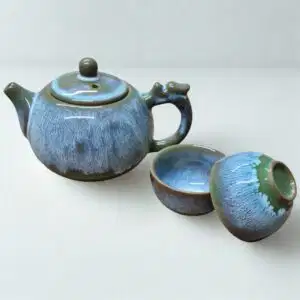 The Ocean Blue Teapot for One | Aqua Teal Tea Set with 2 Cups features a blue and green glazed finish, perfect for enjoying tea solo or pairing with your favorite cups.