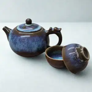 The Ocean Blue Teapot for One | Aqua Teal Tea Set with 2 Cups features a brown and blue glaze, complete with matching cups and lid—an elegant addition to any tea cups collection.
