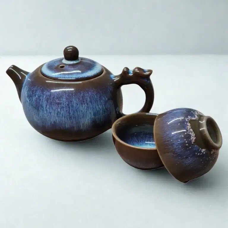 The Ocean Blue Teapot for One | Aqua Teal Tea Set with 2 Cups features a brown and blue glaze, complete with matching cups and lid—an elegant addition to any tea cups collection.