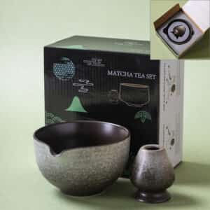 A Kiln-Glazed Matcha Bowl & Whisk Holder Set – 2 Piece | Stone sits before a box labeled 