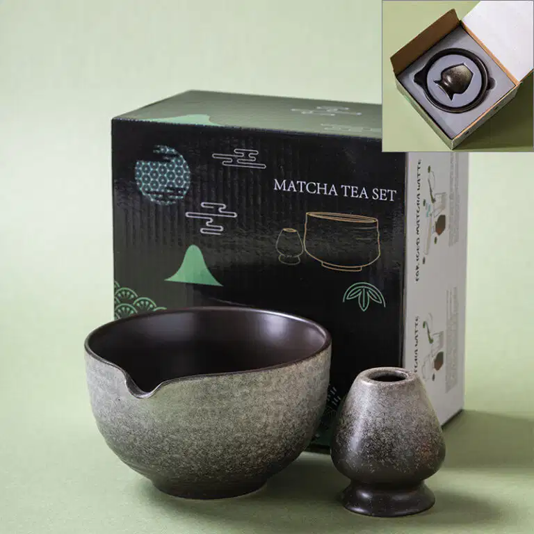 A Kiln-Glazed Matcha Bowl & Whisk Holder Set – 2 Piece | Stone sits before a box labeled 
