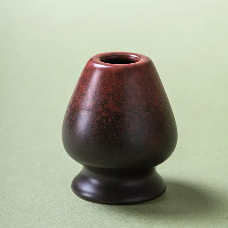 Ceramic chasen holder in rust red iron glaze for bamboo matcha whisk — stoneware, hand-finished, kaki glaze.