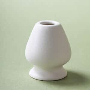 Ceramic chasen holder in matte white stoneware for bamboo matcha whisk, clean, minimal, hand-finished.