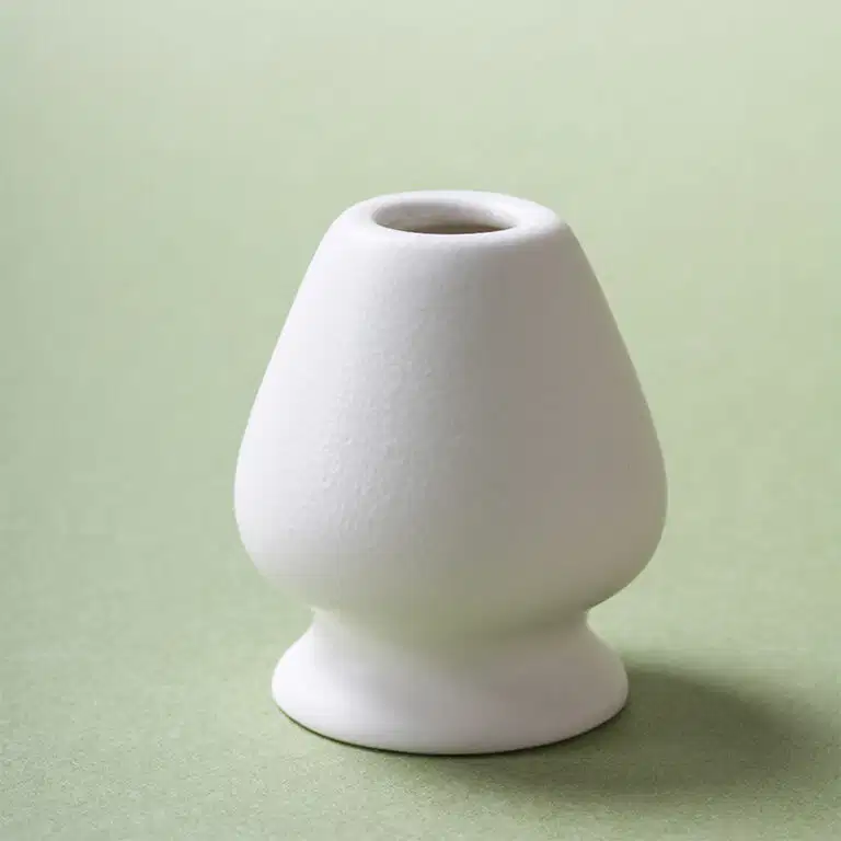 Ceramic chasen holder in matte white stoneware for bamboo matcha whisk, clean, minimal, hand-finished.