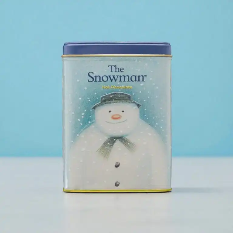 A rectangular tin with a blue lid features an illustration of a snowman wearing a hat and scarf, labeled